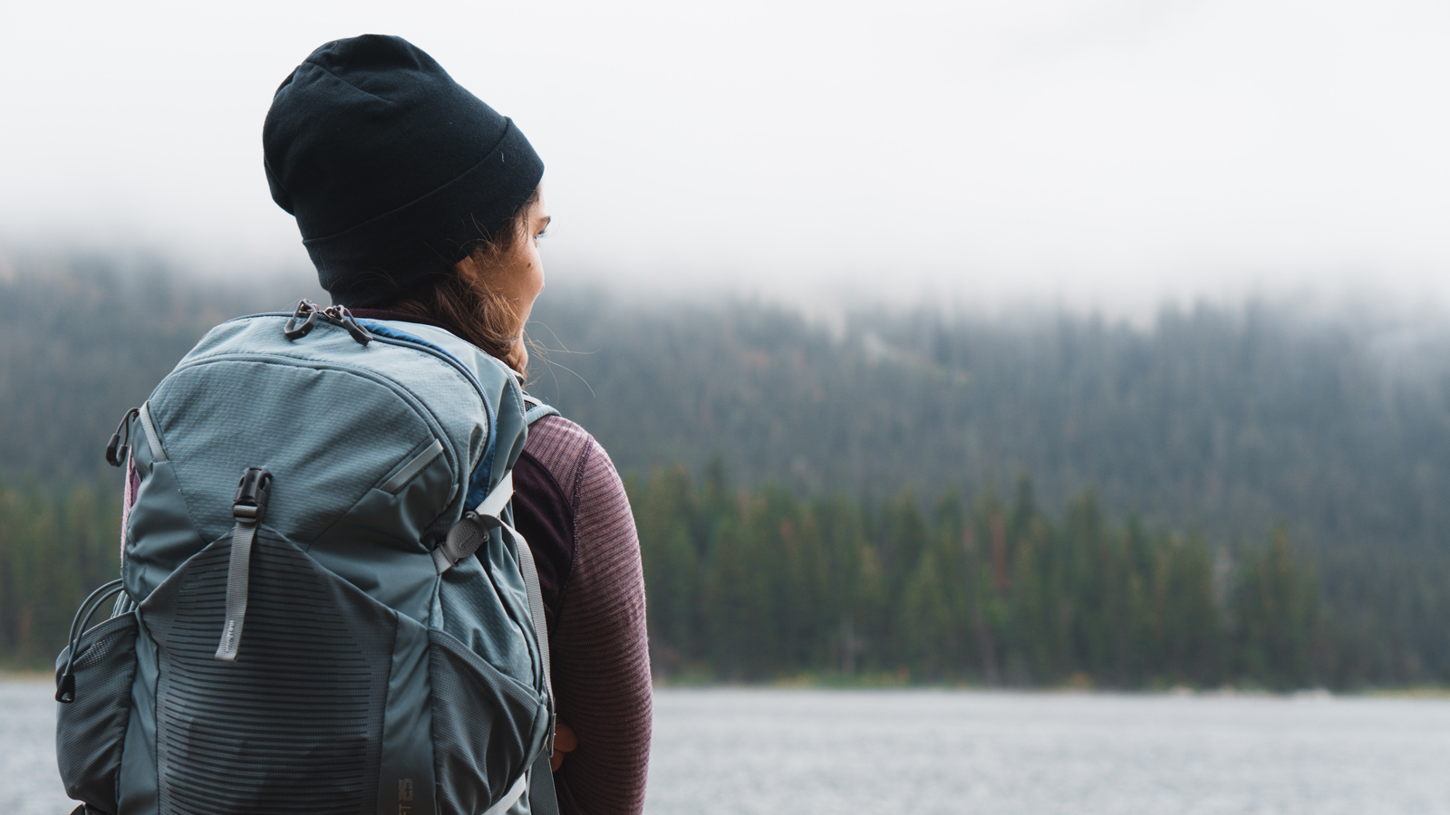 A woman preparing to embark with a backpack